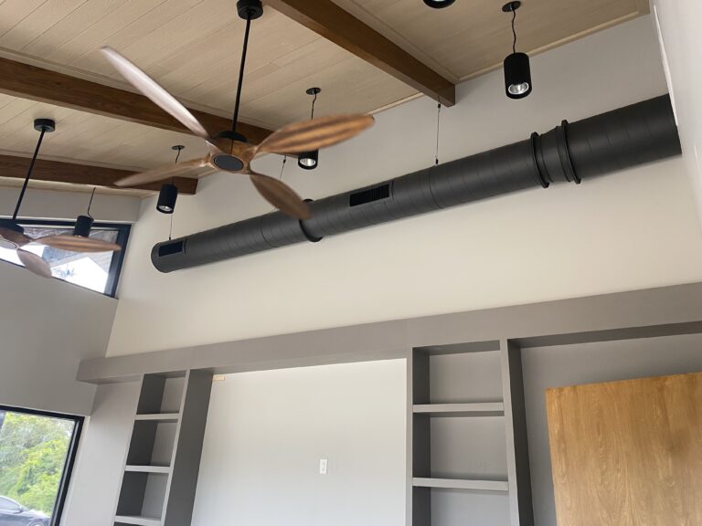 Black metal ductwork branching through the open ceiling of a new construction office, installed by Extreme Temp Air Conditioning & Heating
