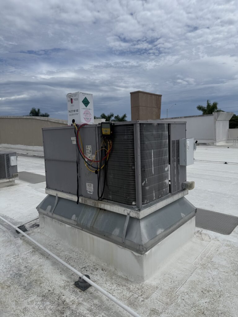 Commercial rooftop AC unit back in service after an Extreme Temp condenser coil replacement at a Naples, FL dental office
