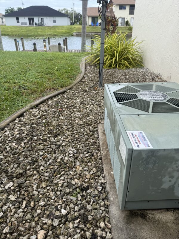 AC condenser at a canal-front home in Cape Coral, FL serviced by Extreme Temp Air Conditioning & Heating