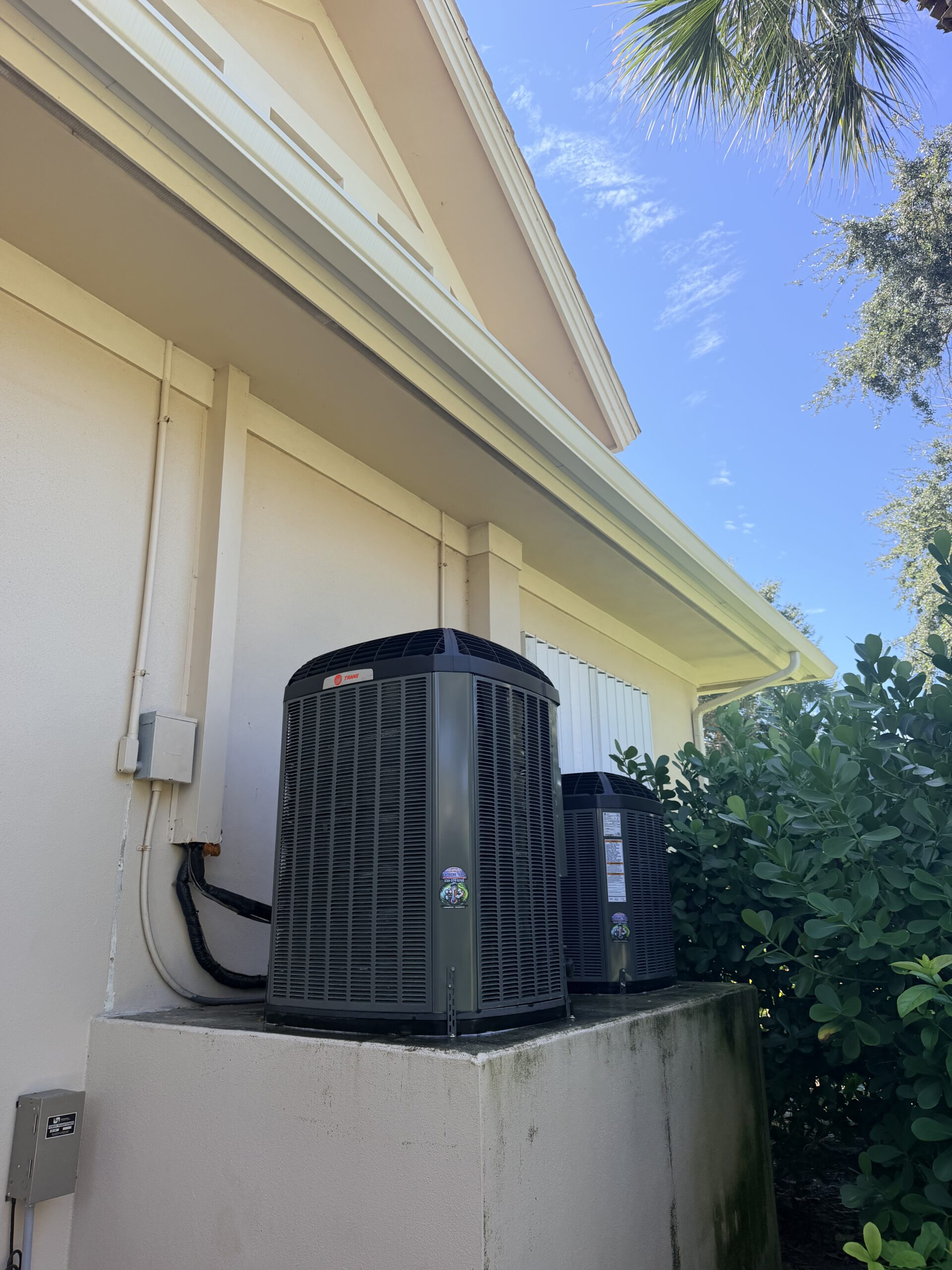 AC condensers on a stand at a home in Port Royal, Naples, FL, serviced by Extreme Temp