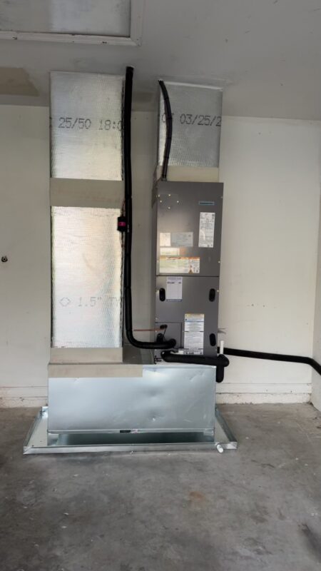 Air handler relocated by Extreme Temp from a horizontal hanging position to a vertical install in a Fort Myers, FL garage, making room for a high-efficiency system