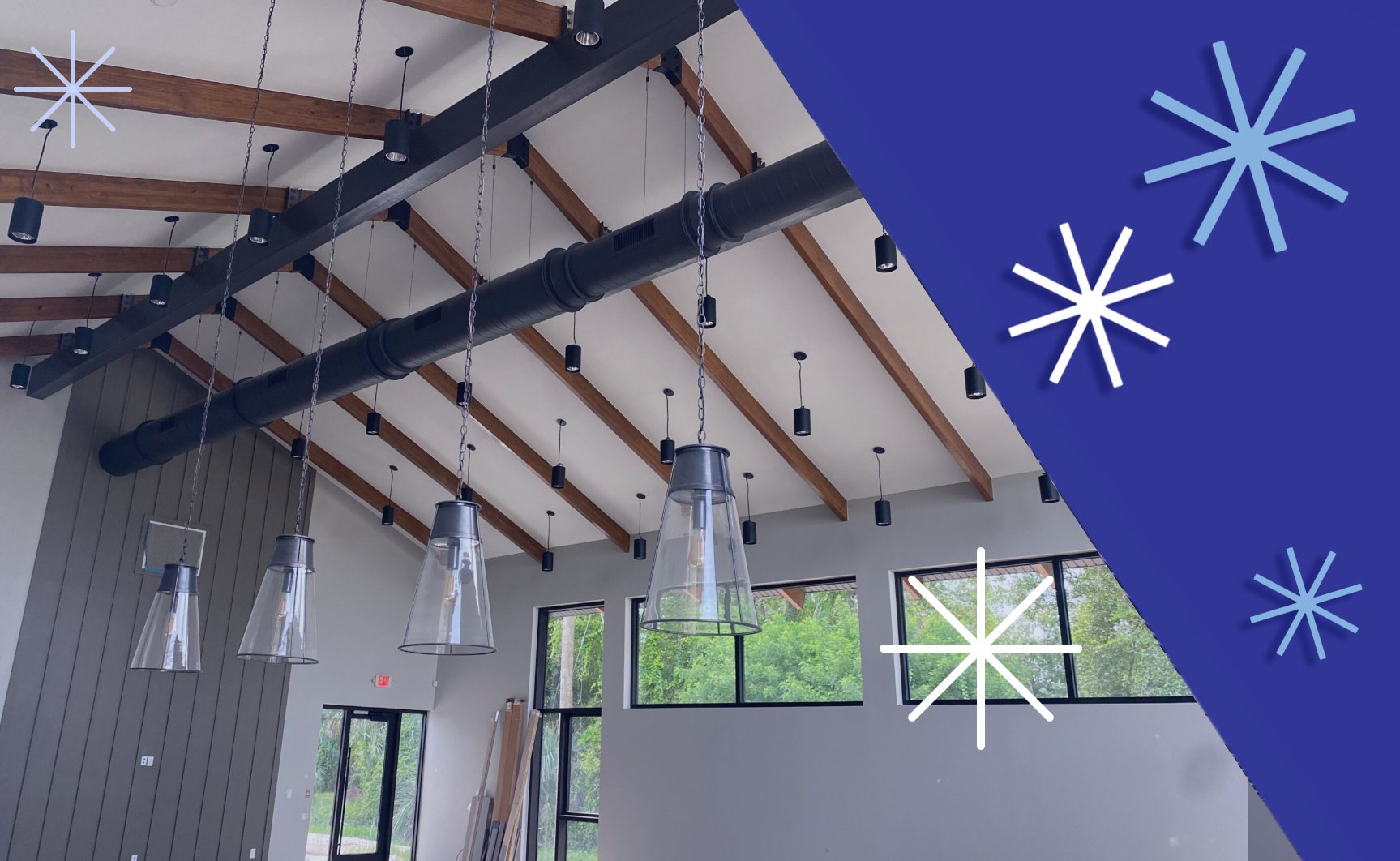 Exposed black spiral metal ductwork installed by Extreme Temp under wood-beam ceilings in the new Capling Leveling office building